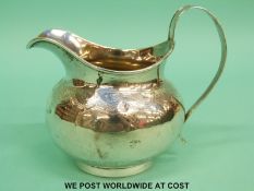A Georgian hallmarked silver cream jug, height 10cm,