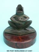An Art Deco bronze figural frog pen holder or inkwell mounted on a burr walnut circular base.