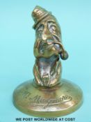 A brass figure of Mr Maymore, marked May & Padmore Ltd.