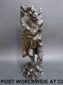 A 19th / 20thC silver wire inlaid hardwood figure of an emaciated immortal beneath a larger figure