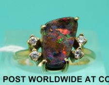 An 18ct gold ring set with a black opal and two diamonds (size M)
