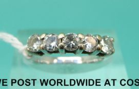 A white metal ring set with five round brilliant cut diamonds (size J)