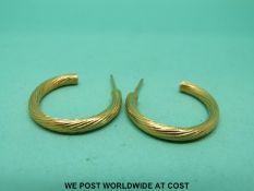 A pair of 9ct gold hoop earrings with textured finish