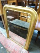 A gilded pine mirror with cushion frame and beaded surround,