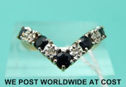 A 9ct gold ring set with diamonds and sapphires in a v shape (size O)