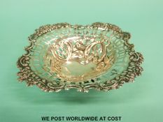 An Edward ViII hallmarked silver pierced bon bon dish raised on three bun feet,