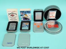Four Zippo lighters comprising Jim Beam, Titanic, Oblivion and Budweiser,