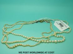 Three strands of pearls, one with platinum clasp, one with 9ct white gold clasp,