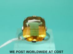 A white metal ring set with a large citrine and diamonds to the shoulders (size R)