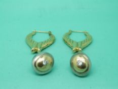 A pair of 9ct gold earrings and a pair of silver and 18ct gold earrings