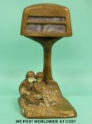 An Arts & Crafts bronze or brass electric lamp in the form of a tree with two figures beneath
