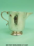 A white metal jug converted from a Goldsmiths & Silversmiths company hallmarked silver christening