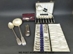 An Elkington & Co plated basting spoon, a cased set of 12 spoons, a ladle,