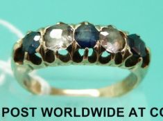A yellow metal ring set with white and blue sapphires (size P)