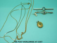 Two yellow metal bar brooches marked 9ct gold, one set with a ruby and seed pearls and one zircon,