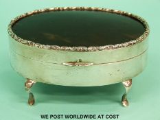 A hallmarked silver and tortoiseshell oval casket raised on four legs, width 11cm,