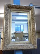A 19thC ornate gilt framed mirror with extensive foliate decoration (67 x 51cm)