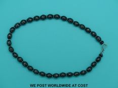 A Yemen black coral prayer bead necklace with 35 white metal inlaid beads separated by white metal