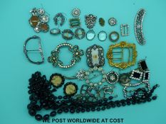 A collection of buckles manly set with paste and some silver,