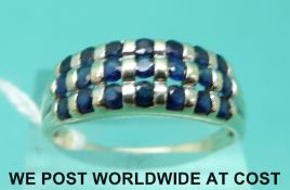 A yellow metal ring marked 14k set with three rows of sapphires (size V)