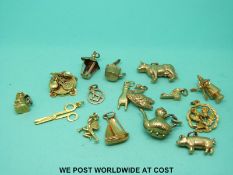 A quantity of 9ct gold and yellow metal charms to include Masonic interest, a cow, sheep,