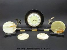 An Art Deco mantel clock garniture with brass bird decoration and inlaid onyx