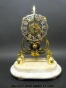 A 19thC skeleton timepiece on a marble stand,