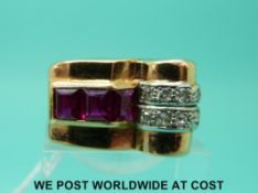 A large yellow metal ring set with three step cut synthetic rubies and ten old cut diamonds in a
