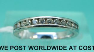 An 18ct gold half eternity ring set with diamonds (size H)