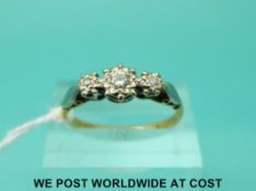 An 18ct gold ring set with three diamonds in an illusion platinum setting (size Q)