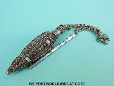 A middle eastern white metal scent bottle with raised decoration, height 11.