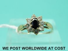 A 9ct gold ring set with a sapphire surrounded by cubic zirconia (size J)