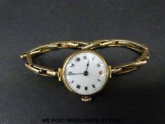 A 9ct gold ladies wristwatch with enamel face