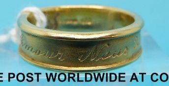 An 18ct gold ring by Laura Lee with French script 'Amour Nous Unité' or 'Love Unites Us', (6.