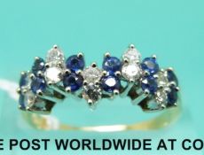 An 18ct gold ring set with alternating diamonds and sapphires (size N)