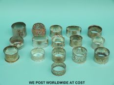 A collection of hallmarked silver and plated napkin rings,