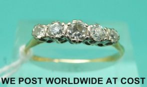 A yellow metal ring set with five diamonds in a platinum setting (size P/Q)
