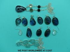 Nine silver pendants set with labradorite,