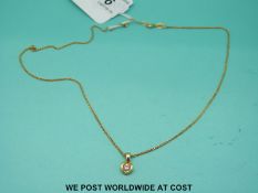A yellow metal pendant set with a diamond of approximately 0.1ct, on 18ct gold chain (3.