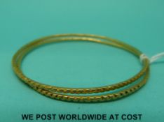 Two child's size Middle Eastern yellow metal bangles (11.