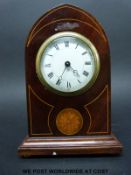 A small Edwardian mitre shaped mantel timepiece with string boxwood inlay and shell decoration,