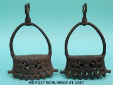 A pair of 17th/18thC Spanish or Portuguese pierced iron stirrups with various correspondence from
