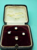A set of four 9ct gold studs set with opalescent stones, in original box.