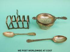 A feature hallmarked silver tea strainer on stand,