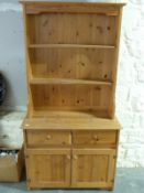A pine dresser with plate rack above (W92 x D38 x H176cm)