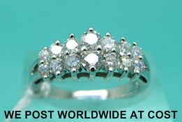 A 14ct white gold ring set with fourteen graduated diamonds (size M)