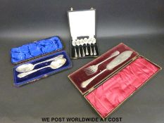 A quantity of cased plated cutlery comprising a pair of berry spoons,