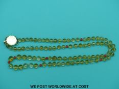 A glass and coral beaded necklace with a yellow metal clasp marked 14K, 75cm long.