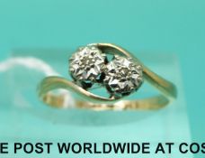 A 9ct gold ring set with two diamonds in a platinum twist setting (size K)