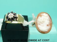 A 9ct gold ring set with a diamond surrounded by sapphires and a yellow metal ring set with a cameo